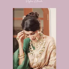 A close-up on the magnificent jewelry we curated for this bridal look. We layered multiple polki and emerald necklaces of varying lengths to create a truly regal effect that beautifully complements the golden saree.