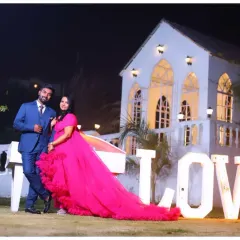 A dramatic night-time maternity shoot. Using professional lighting, I can create a cinematic and memorable scene with props like the illuminated 'LOVE' sign to add a unique touch to your photos.