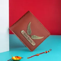 A beautiful Rakhi gift featuring a personalized wallet with a name and wings charm, shown with a traditional Rakhi and a diya.