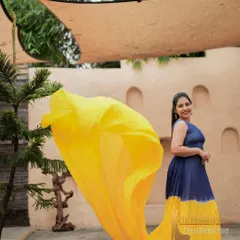 The blue and yellow dual-tone gown is captured here in mid-air, showing how the contrasting colors create a vibrant swirl. This gown is perfect for dynamic, action-filled shots.