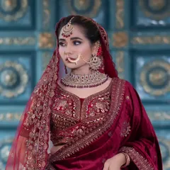 For my North Indian brides, I have a wide collection of Kundan and Jadau jewellery. This bridal set features a heavy choker with deep red stones, a matching maang tikka, and a traditional nath, perfect for a lehenga.