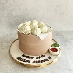 A cake for a momo lover! This entire dim sum steamer basket is a cake, and the momos on top are made of fondant. It was a delicious challenge to make it look so realistic.