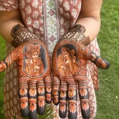For brides who want a divine touch, I create portraits of Radha and Krishna. This design features the divine couple on the palms, surrounded by delicate lotus and traditional patterns, using negative space to make the figures pop.