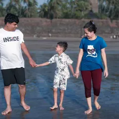 A candid moment of a family walking together on the beach. I love capturing these simple interactions that show the natural bond between parents and their child.
