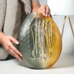 This image shows the scale of my large dual-tone glass vase. It's a substantial piece of art, perfect for a modern living room or entryway.