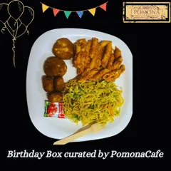 A sample birthday party meal, plated to show a delicious combination of hakka noodles, penne pasta, and vegetable cutlets. My birthday boxes are designed to be a complete, satisfying meal for guests of all ages.