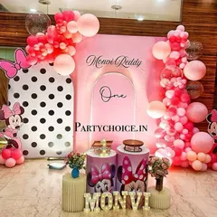 A modern and chic Minnie Mouse theme for a first birthday. We used a combination of polka-dot and solid pink backdrops, creative balloon arrangements, and light-up letters for a stylish celebration.