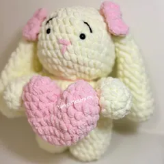 This big plush bunny is holding a soft pink heart. It's made with a thick, chunky yarn that is incredibly soft to the touch, perfect for a Valentine's or birthday gift.