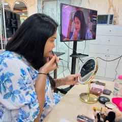 I always demonstrate techniques on a model first, explaining each step clearly. Here, I'm teaching a self-makeup class how to apply lip liner for a defined and long-lasting lip color.