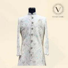 The front view of our signature ivory and pastel sherwani. Notice how the detailed buttons and fine embroidery come together to create a balanced and majestic look for your wedding day.