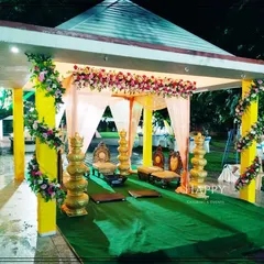 An intimate outdoor mandap setup nestled within a garden gazebo. This design blends traditional elements like brass lamps and floral arrangements with the beauty of nature, creating a serene and sacred space for your wedding ceremony.