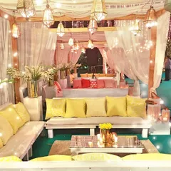 A cozy and magical lounge area I designed for an engagement party. The draped fabrics, warm lighting from the Moroccan lanterns, and comfortable seating created an intimate and celebratory space.