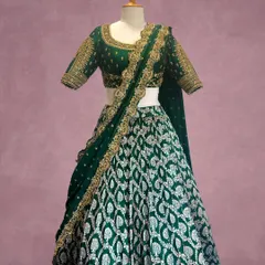 Inspired by the sacred architecture of South Indian temples, this emerald green lehenga is a work of art. The skirt features repeating motifs in silver and gold thread, while the blouse is adorned with detailed zardozi work, making it a regal choice for a wedding or grand reception.
