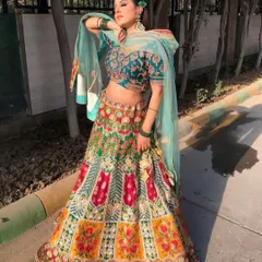 A different pose in our popular multi-color lehenga, showing its beautiful flare and the way the light teal dupatta complements the vibrant skirt.