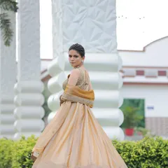 Back and side views of the custom golden lehenga, showing its beautiful silhouette and the delicate organza dupatta.