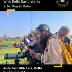Participants using binoculars and a spotting scope during our "Morning Chirps" bird walk at Asita East. We provide equipment and guidance to ensure everyone gets a great view.