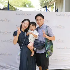 A happy family smiles for a photo at one of our community events, showcasing our diverse and international family base.