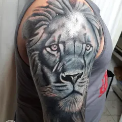 A close-up view of the lion's face. Notice the fine details in the fur and the intensity in the eyes. This level of detail is what makes a cover-up successful, drawing the eye to the new art.