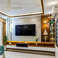 This living room showcases a full-wall media unit we designed. It features a mix of warm wood and white laminate, with integrated backlighting to create a cozy ambiance, and combines open shelving for display with closed cabinets for clutter-free storage.