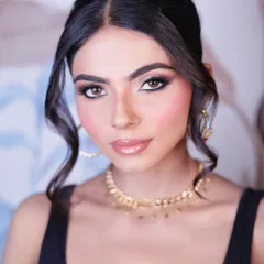 A direct, confident gaze. This close-up highlights the sharp winged eyeliner and perfectly defined brows, key elements of a polished party makeup look.