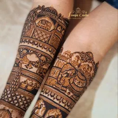 A close-up of a bridal start-up, showing the intricate details of the forearm design, including peacocks, elephants, and architectural motifs.