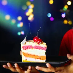 Here, I wanted to capture the fun of a rainbow pastry. Holding the slice up against a backdrop of colorful bokeh lights creates a celebratory, magical feel that makes you want to take a bite.