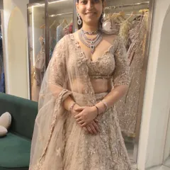 My clients are the prettiest. This lovely lady is trying on a beautiful beige embroidered lehenga, paired with a delicate diamond and sapphire necklace, perfect for a family member's wedding.