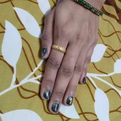 A dark and moody cat eye effect on short, natural nails. The magnetic polish creates a silver streak that moves in the light, giving it a really cool, galactic vibe. I added a gold foil accent for a touch of contrast.
