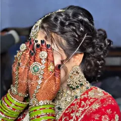 I love this shot because it captures everything. The intricate bridal mehndi, the beautiful jewelry, and the classic bridal hair updo all come together. It shows how every detail is considered to create a cohesive and stunning final look.