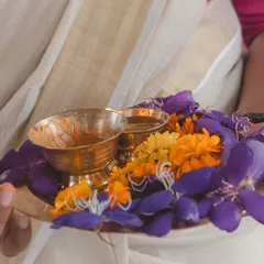 A traditional welcome platter with fresh flowers and kumkum. It's a small gesture that sets a warm and hospitable tone for the entire wedding celebration.