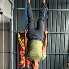 A slightly different angle of the inverted aerial pose, showcasing the control and balance involved.
