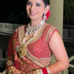 A close-up of Manika's radiant bridal look. I focused on creating a smooth, glowing complexion that would last all day, paired with a neutral lip to balance her magnificent jewelry and classic red outfit.