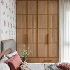 This primary bedroom radiates tranquility with its soothing palette of mauve grey and pastel green. The tuck-in wardrobe features soft wood tones and elegant grooved details for a touch of classic charm.