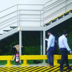Here you can see my team during the installation process for the staircase green wall. We take great care to ensure every panel is perfectly fitted and the system is set up correctly for the plants to thrive.