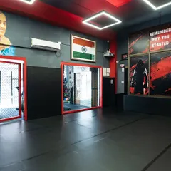 Another view of our facility, showing the open mat space, mirrors for technique correction, and the motivational quote: "Remember Why You Started."
