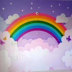 I love working on kids' rooms because the possibilities are endless. This vibrant rainbow and clouds mural creates a cheerful and imaginative wonderland, turning a plain wall into the highlight of the room.