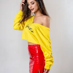 A side-profile shot from the "I'm Lovin' It" series. The model's smile and the bright colors of her outfit create a happy and energetic vibe in this studio fashion shoot.