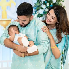A candid moment as parents admire their newborn during a family ceremony. These quiet, emotional shots are priceless.