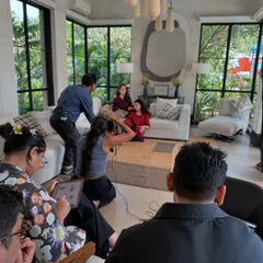 A wider view of a shoot in progress. It shows the full team at work, from me behind the camera to assistants and clients observing the process.