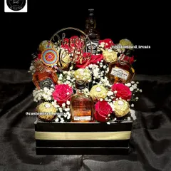 For a touch of class, I design premium liquor hampers like this one. It combines miniature alcohol bottles with Ferrero Rocher chocolates and fresh roses, creating a sophisticated and celebratory gift for any special occasion.