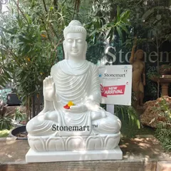 This 3-foot Buddha statue is carved from a single block of white marble. The Abhaya Mudra posture signifies protection and fearlessness, making it a perfect serene addition to a home or garden.