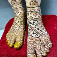 A closer look at the intricate details of the full-coverage leg mehendi, showing the fine lines and shading.