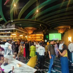A wide view of one of our mixers in full swing. You can see people gathered in small groups, chatting naturally. This is what real-life social networking looks like.