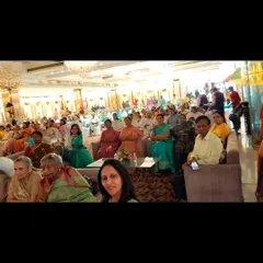 The family and friends at the 95th birthday event, watching the sand art performance with rapt attention.