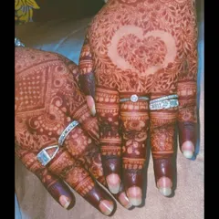 A heart motif left as negative space in the palm, symbolizing love. This is a popular and beautiful way to personalize your engagement henna.