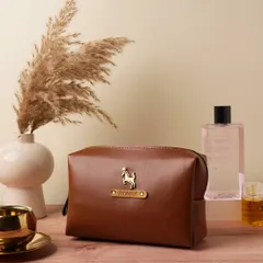 A close-up of the personalized vegan leather pouch, customized with the name 'Ronak' and a horse charm. It's a stylish and practical accessory for organizing essentials.