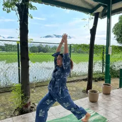 A powerful Warrior I pose, feeling grounded in the earth and reaching for the sky. Retreats are a perfect time to deepen your asana practice.