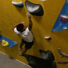 A climber mid-flight, reaching for a hold during our first exclusive Dyno session. These workshops are all about capturing that perfect moment of power and precision.