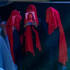 A creative and personal groom entry. The groom's friends hold up pictures of the bride, creating a sweet and surprising reveal moment before the main performance.