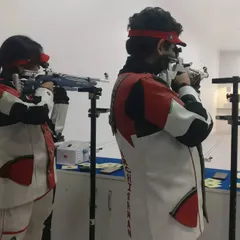 Shooters Shreya Sharma and Archishman Pandey in perfect sync during a 10m Air Rifle training session. The image captures the intense focus required in precision shooting.